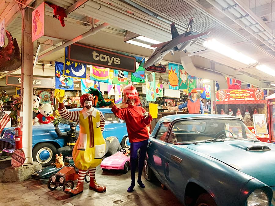 Ronald McDonald next to a blue vintage car at The American Treasure Tour