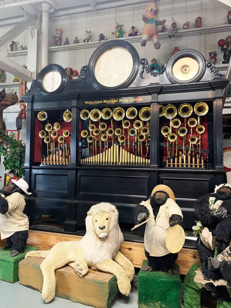 Black Wurlitzer band organ with stuffed animals in front inside The American Treasure Tour