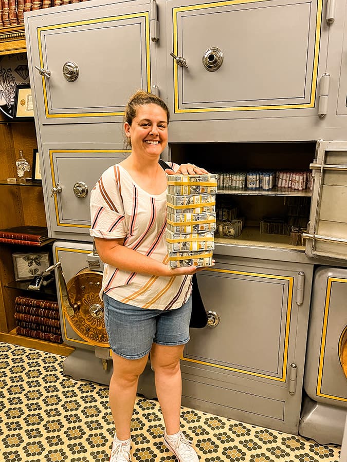 Barbara holding money in Arkansas capitol