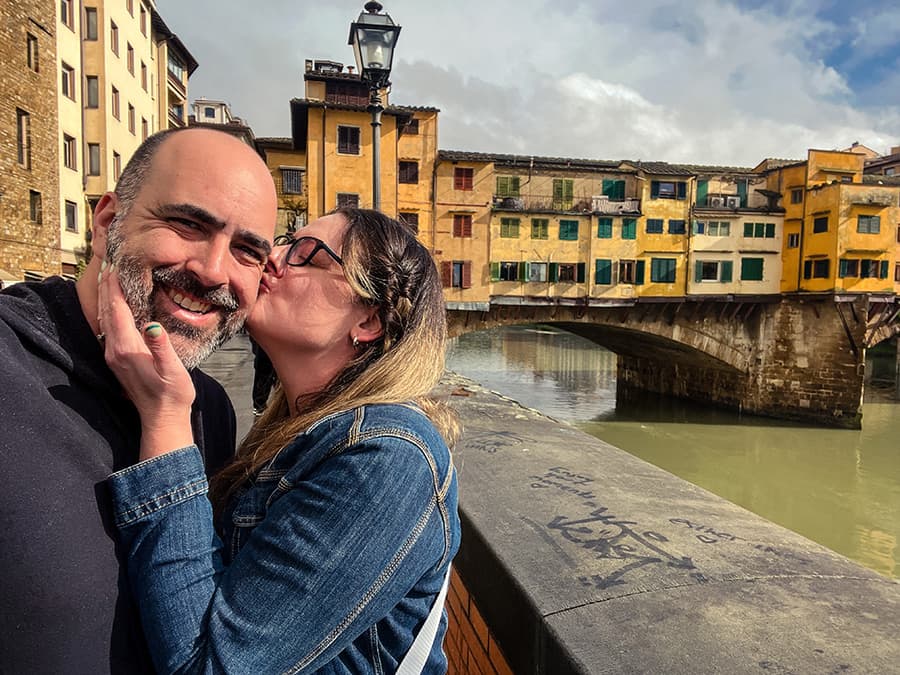 kissing by the bridge in florence