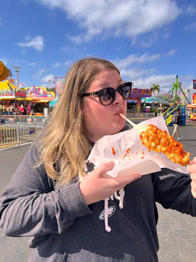 Chrissy eating a potato corn dog at the Florida State fair