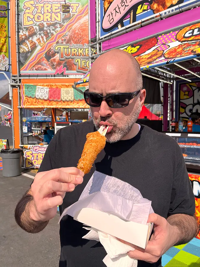 Mark eating a Korean corn dog at the fair